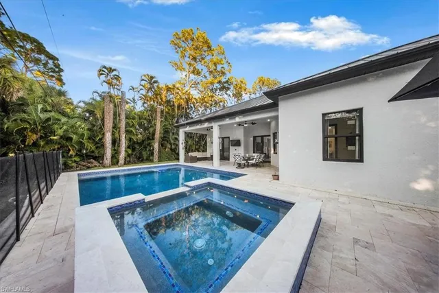 swimming pool view with a seating space