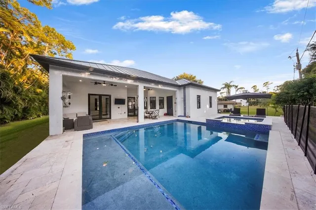 a view of house with swimming pool and sitting area