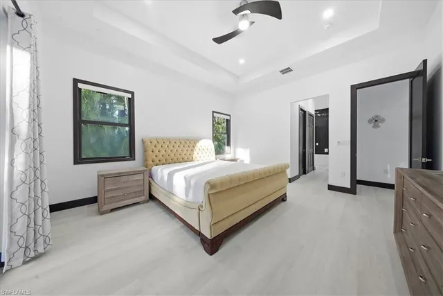 a bedroom with a bed couch and window