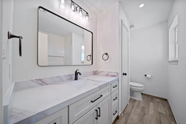 a bathroom with a double vanity sink and a mirror