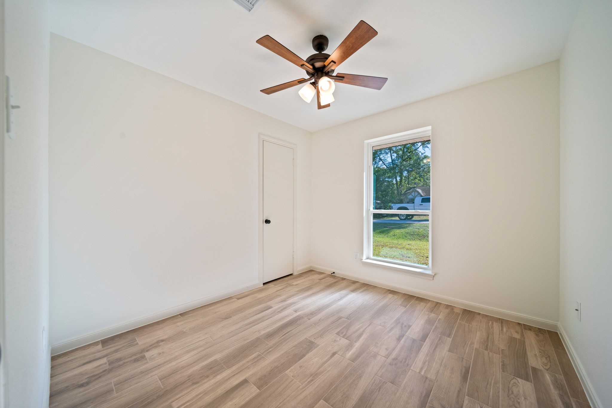 3322 Gary Lane Spring, TX 77380 - Photo 17 of 21 an empty room with wooden floor and ceiling fan