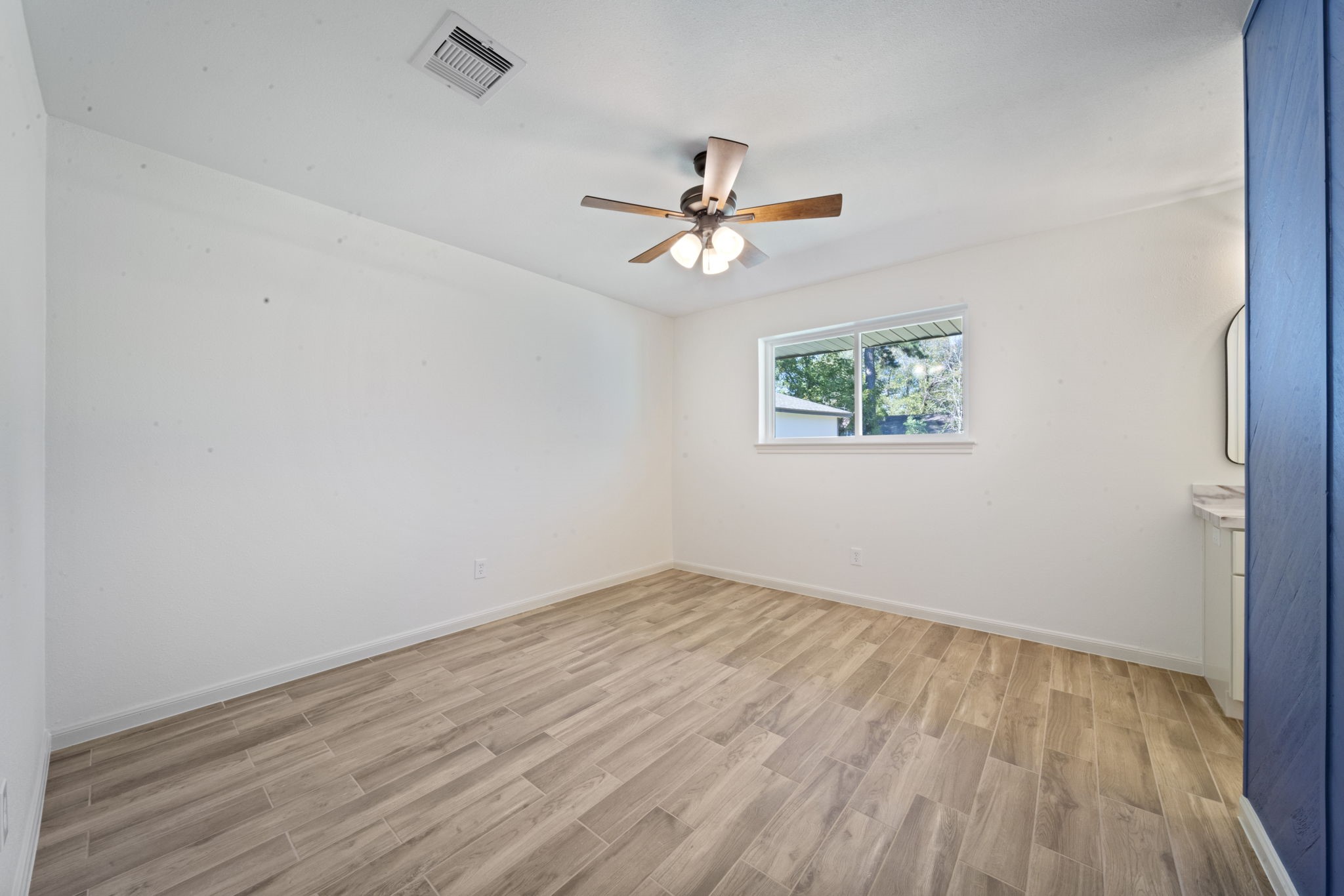 3322 Gary Lane Spring, TX 77380 - Photo 10 of 21 an empty room with wooden floor ceiling fan and window
