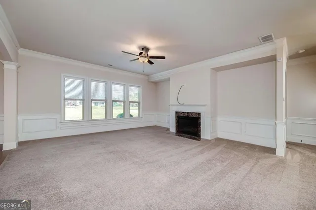 a view of a livingroom with a ceiling fan and window