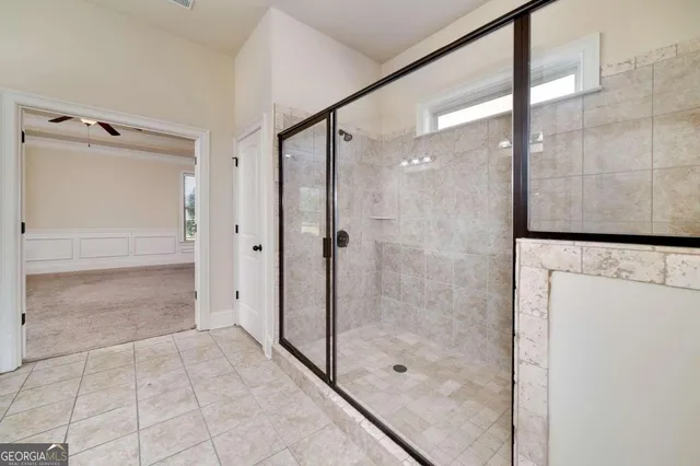 a view of a hallway to room with stair