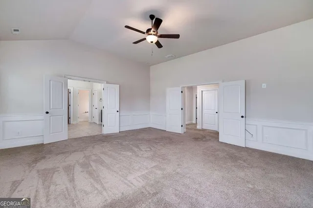 a large bathroom with a granite countertop double vanity sink a mirror and a bathtub