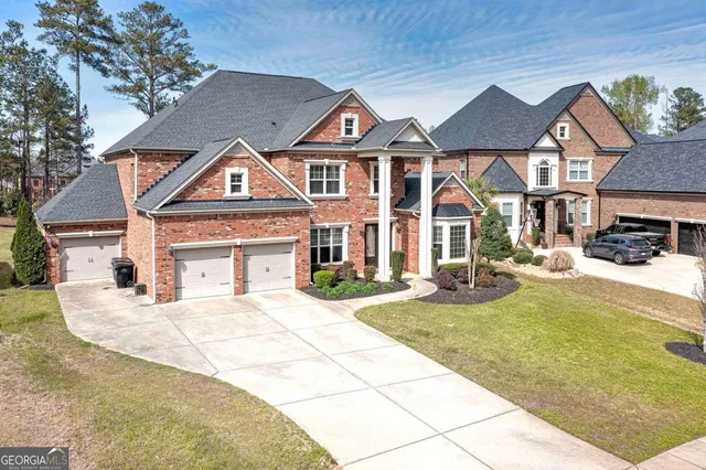 an aerial view of a house with a yard