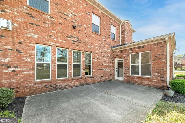 a front view of a building with a garden