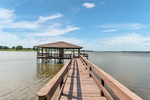 a view of a lake with a large wooden floor and a large bridge