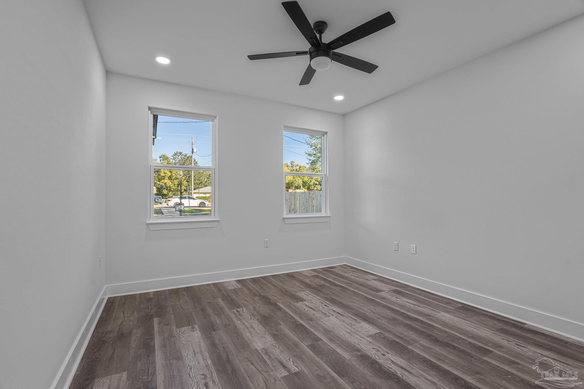 5005 Saufley Field Road Pensacola, FL 32526 - Photo 17 of 27 an empty room with window and ceiling fan