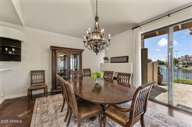 a view of a dining room with furniture and chandelier