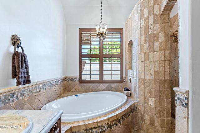 a bathroom with a tub and window
