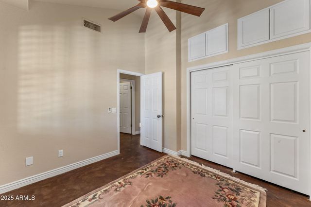 a bedroom with a large bed and a chandelier