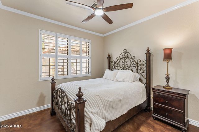 a kitchen with white cabinets and wooden floor