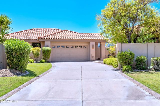 a kitchen with stainless steel appliances granite countertop wooden cabinets a refrigerator and a sink