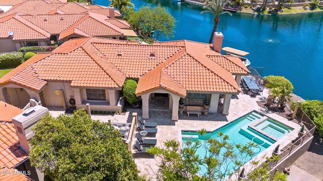 an aerial view of a house with balcony table and chairs