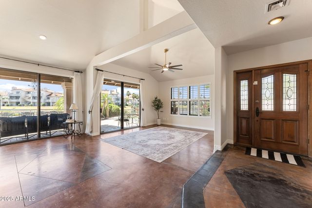 a spacious bedroom with a large bed and large windows