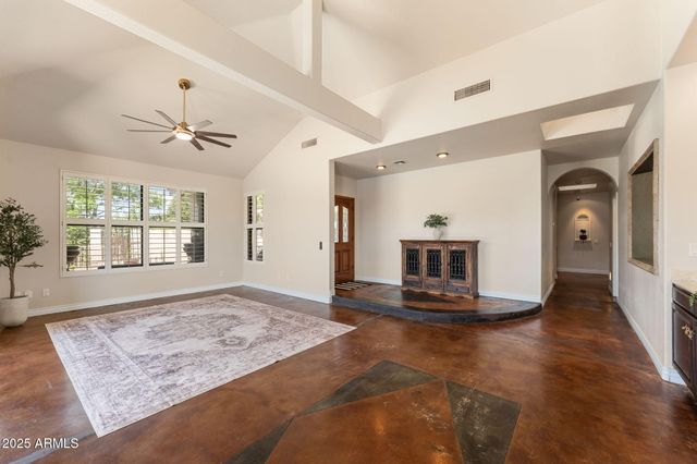 a view of an empty room with a fireplace and a window