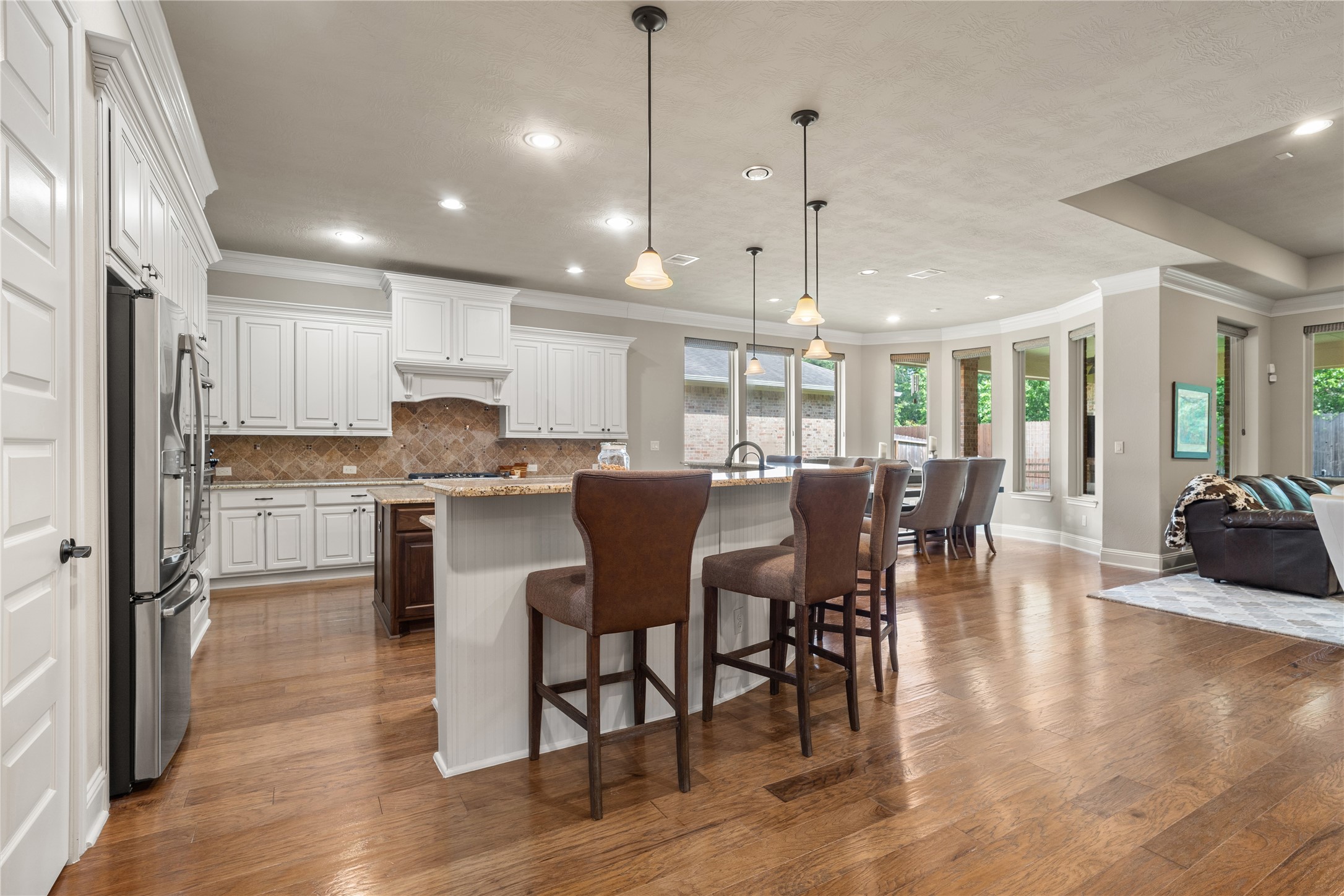 19813 Cullen Ridge Drive Porter, TX 77365 - Photo 10 of 44 This inviting kitchen has tons counter space perfect for cooking and entertaining, with a cozy seating area to enjoy every moment.