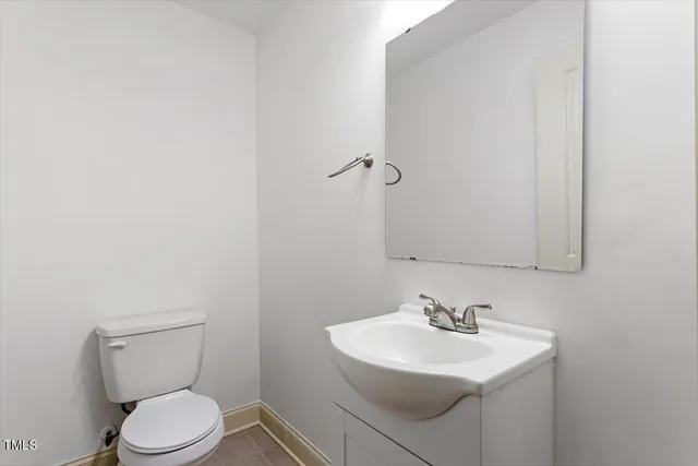 a bathroom with a sink toilet and a mirror