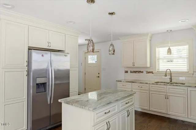 a kitchen with a sink stove and refrigerator