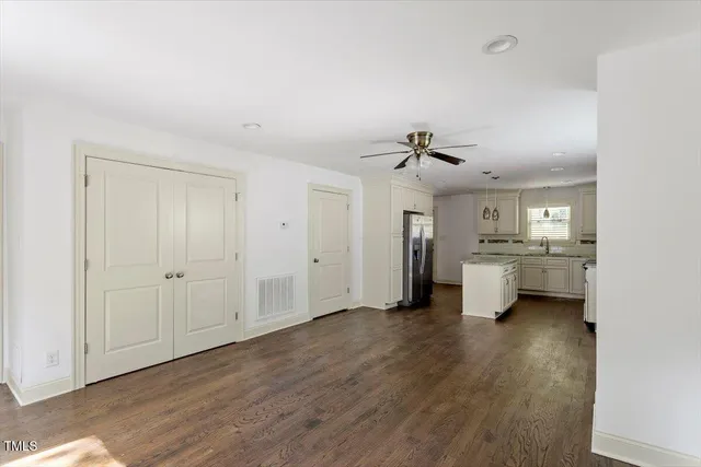 a view of a hallway with a sink and a refrigerator
