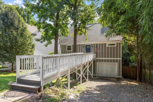 a view of a deck with a fence and a big yard