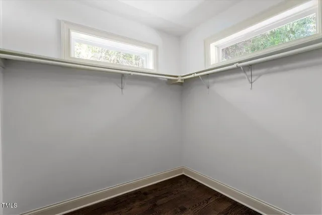 a view of a room with wooden floor and fan