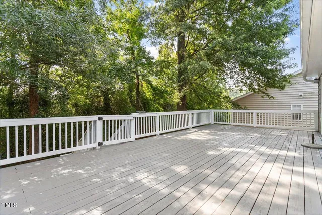 a view of backyard with a wooden fence