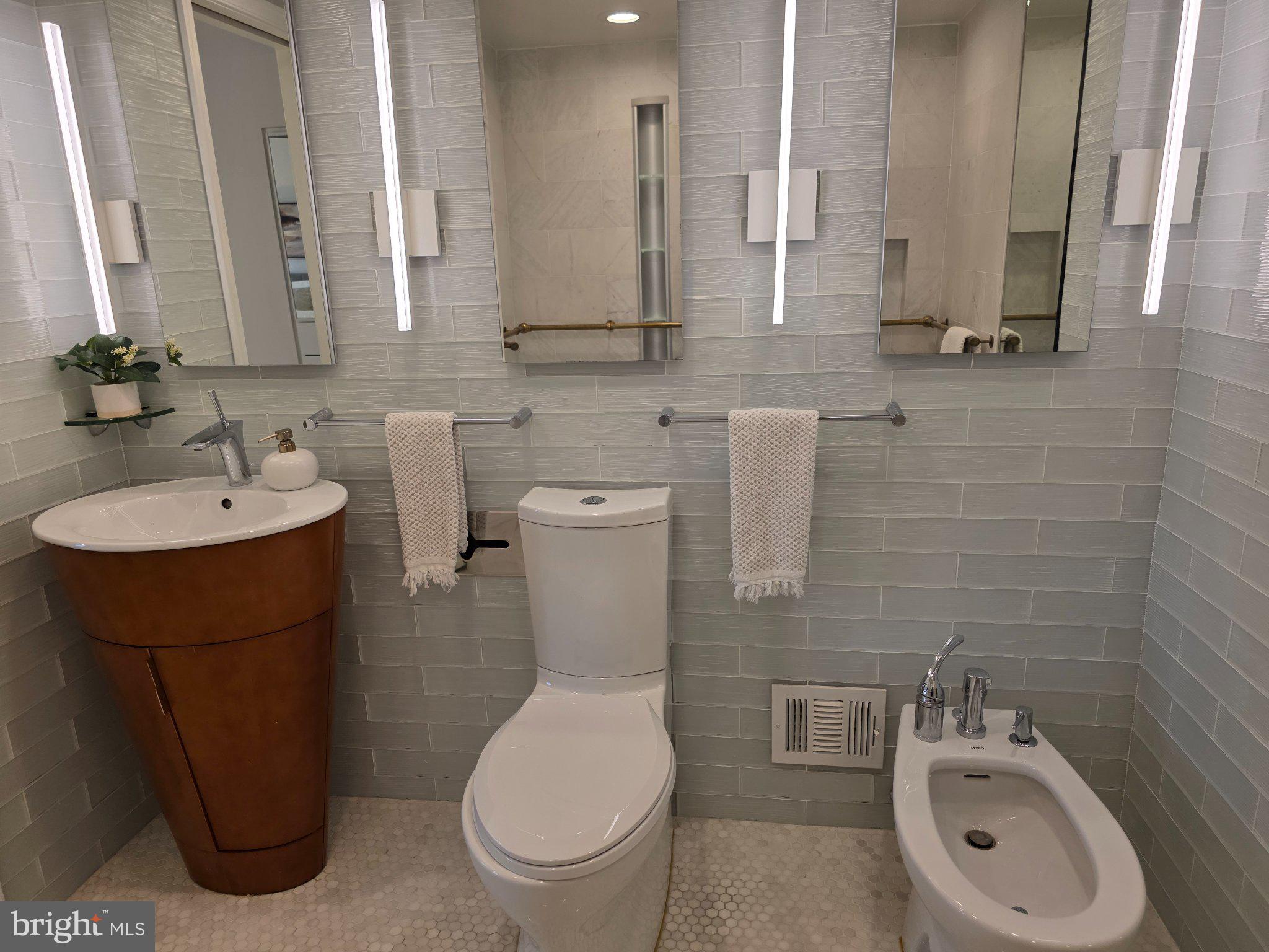 3643 St Mary's Place Northwest Washington, DC 20007 - Photo 25 of 49 a bathroom with a toilet sink and mirror