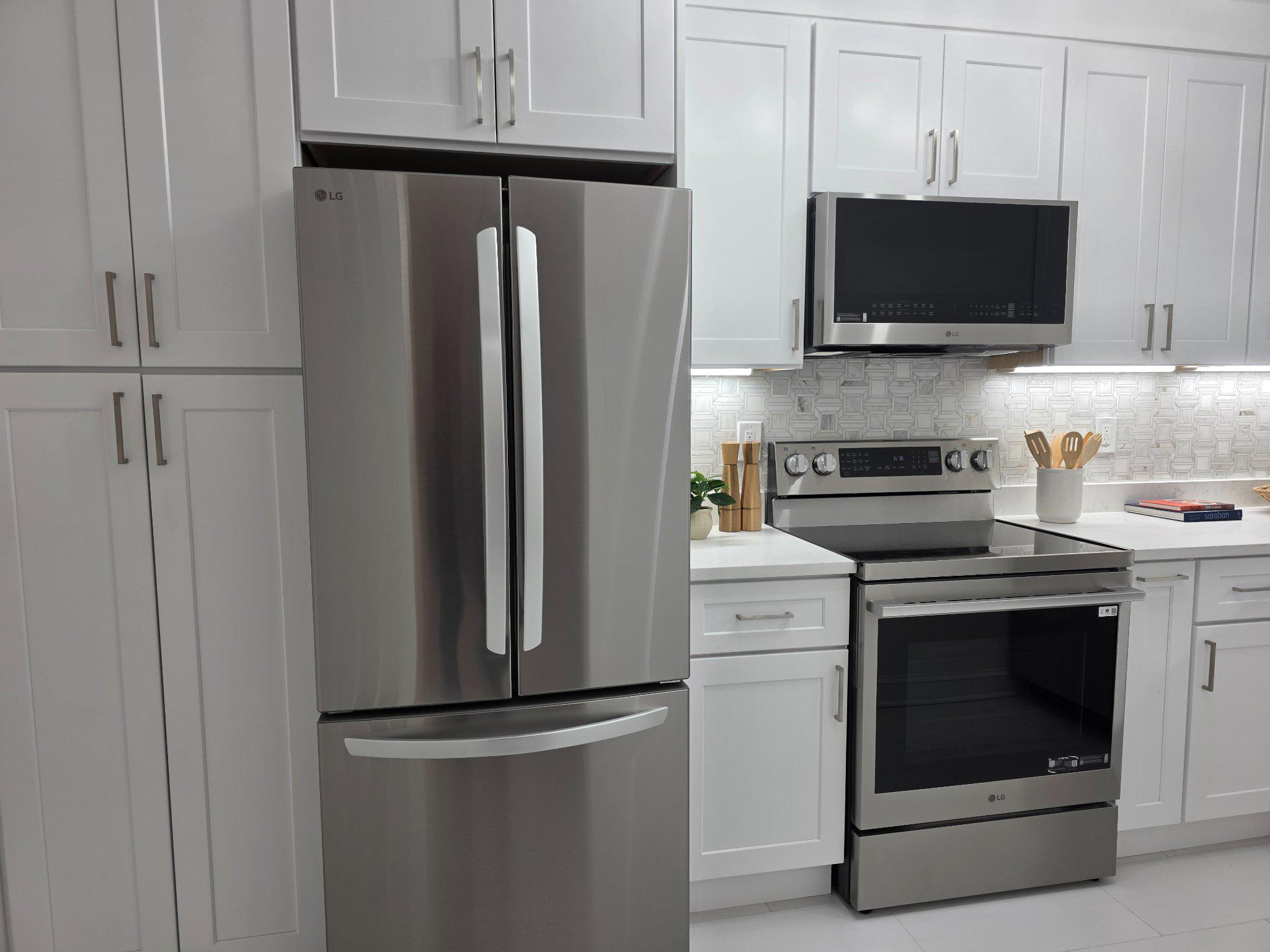3643 St Mary's Place Northwest Washington, DC 20007 - Photo 3 of 49 a kitchen with stainless steel appliances white cabinets and a stove