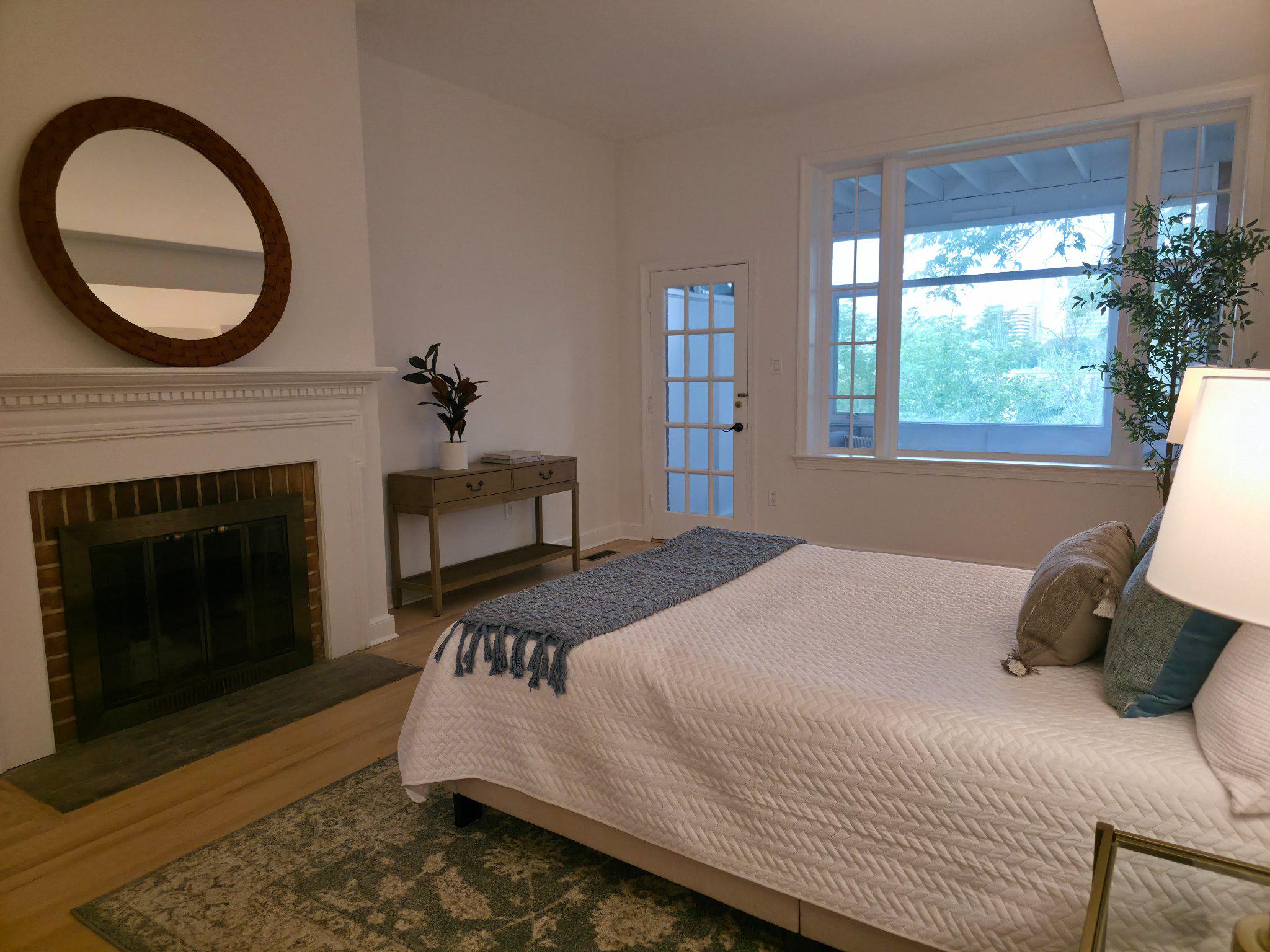3643 St Mary's Place Northwest Washington, DC 20007 - Photo 34 of 49 a bedroom with a bed a fireplace and a large window