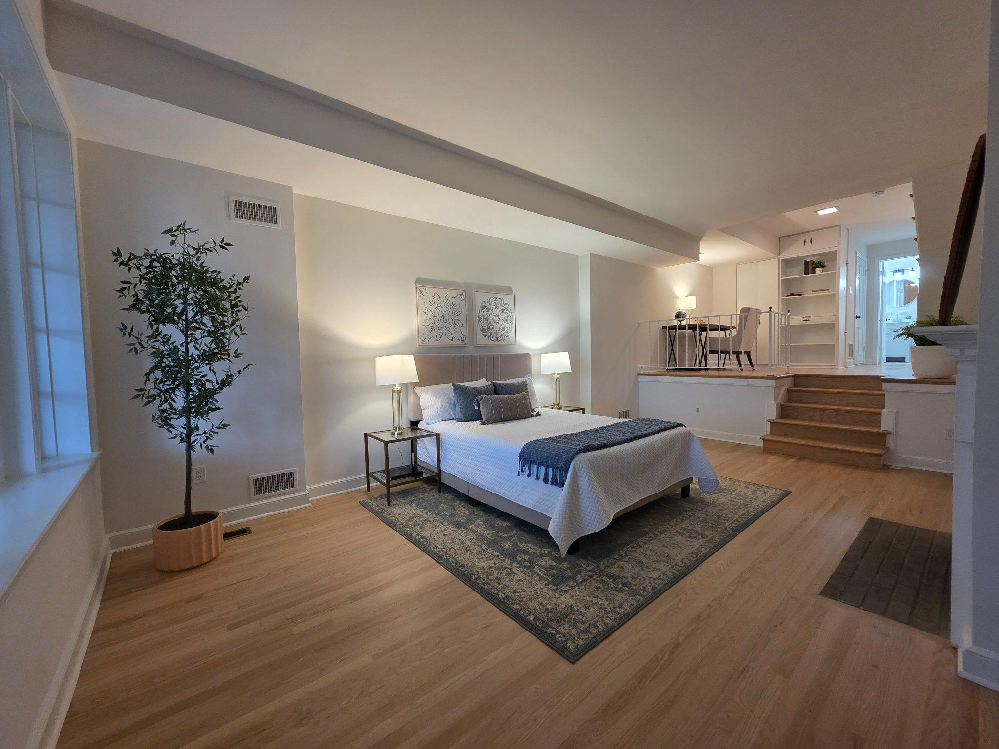 3643 St Mary's Place Northwest Washington, DC 20007 - Photo 35 of 49 a spacious bedroom with a balcony a bed and a potted plant