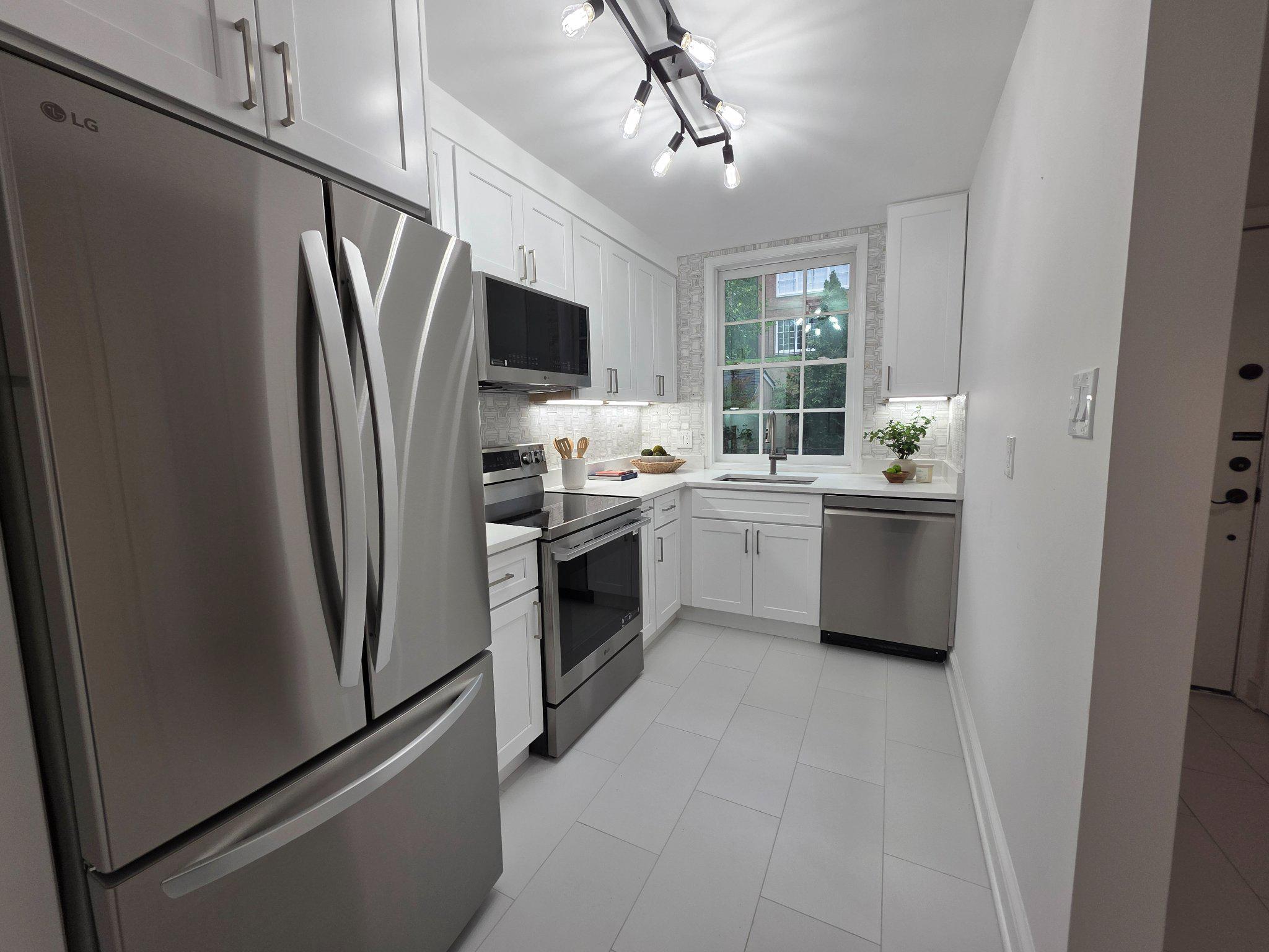 3643 St Mary's Place Northwest Washington, DC 20007 - Photo 4 of 49 a kitchen with a sink stainless steel appliances and counter space