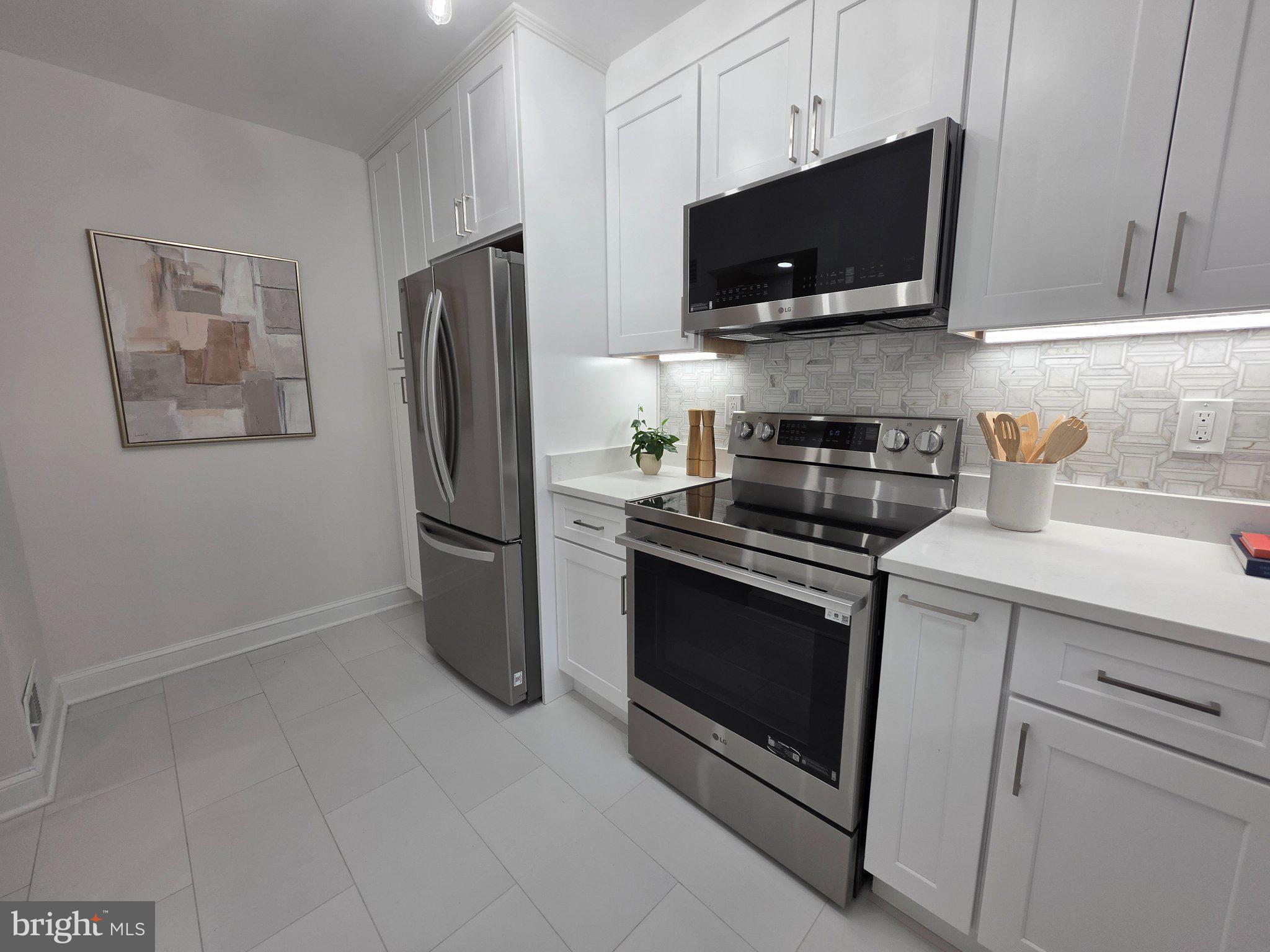 3643 St Mary's Place Northwest Washington, DC 20007 - Photo 5 of 49 a kitchen with stainless steel appliances a stove microwave and refrigerator