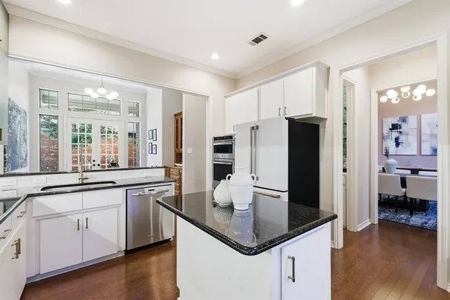 a kitchen with a sink cabinets and chandelier
