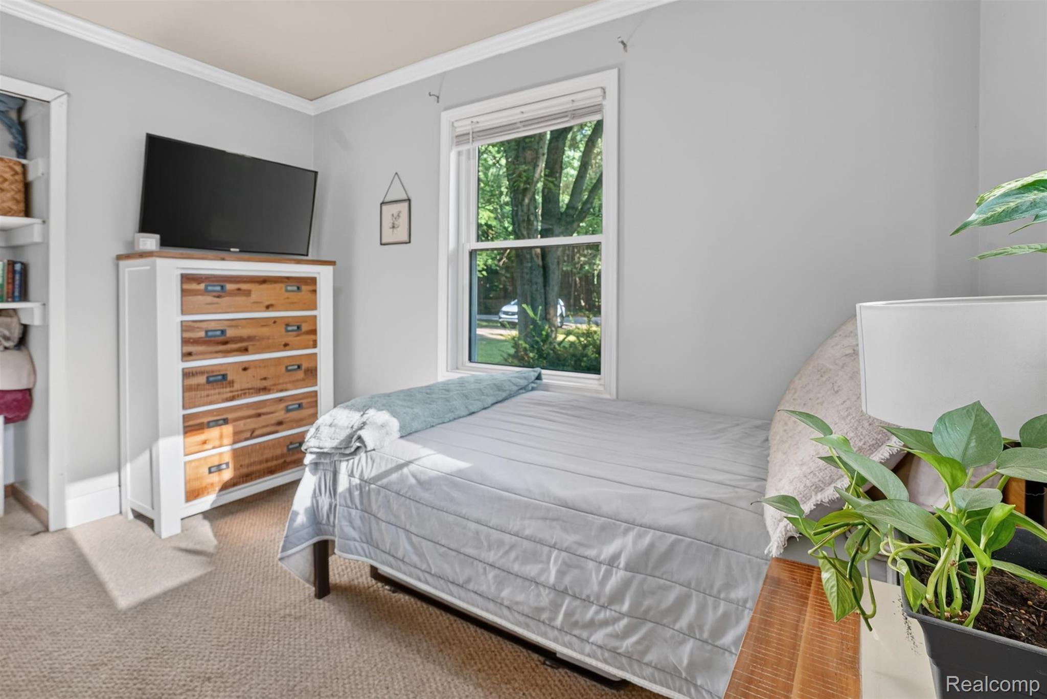8696 West Sargent Road Fowlerville, MI 48836 - Photo 20 of 36 Light-filled interior space featuring neutral wall tones, carpeted flooring, and a large window