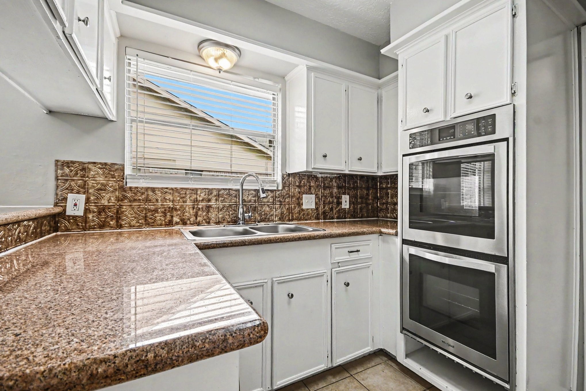 4306 Oneida Street Pasadena, TX 77504 - Photo 9 of 23 a kitchen with granite countertop white cabinets and stainless steel appliances