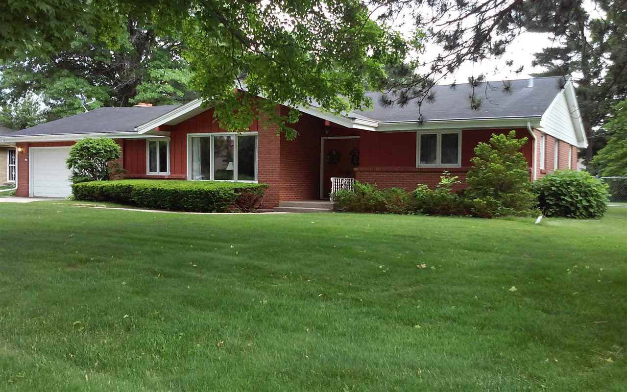 5035 Welsh Road Rockford, IL 61107 - Photo 1 of 15 a front view of a house with a yard and garage