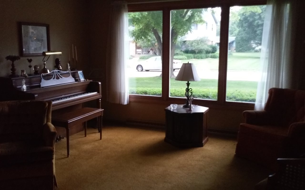 5035 Welsh Road Rockford, IL 61107 - Photo 5 of 15 a living room with furniture and a floor to ceiling window