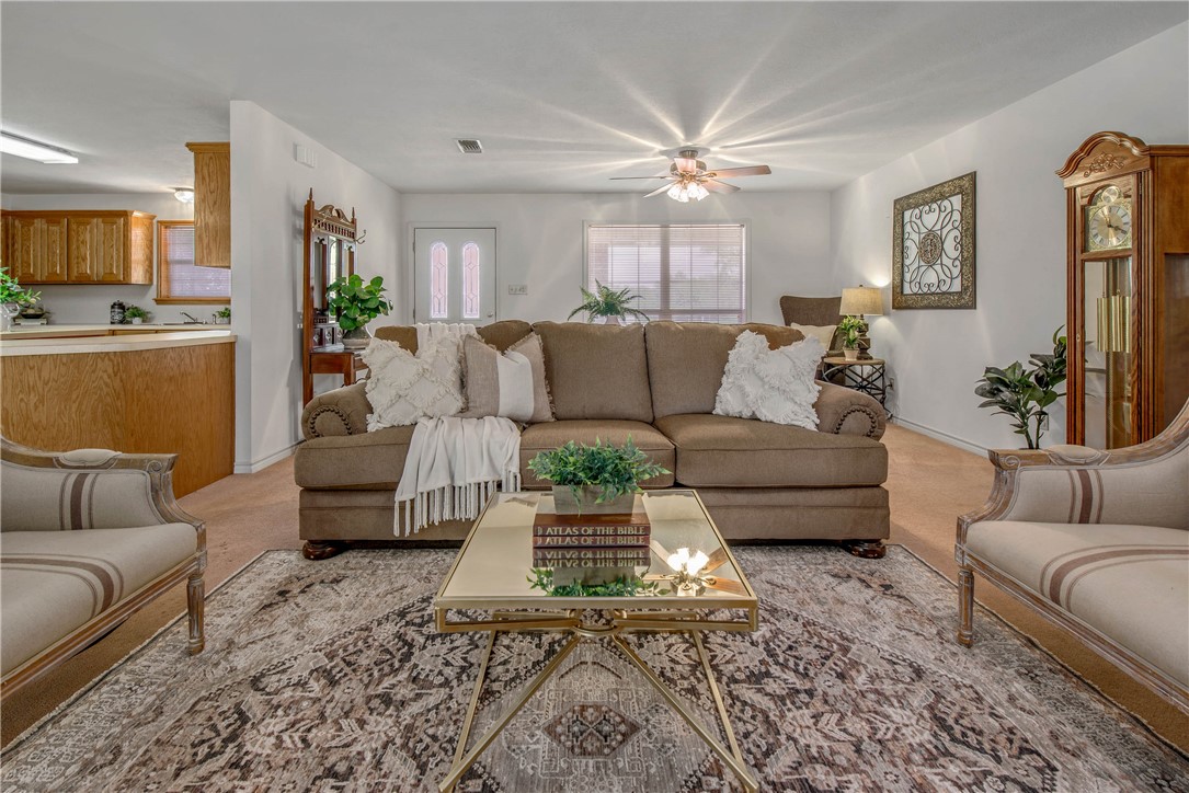 1110 County Road 439 Dime Box, TX 77853 - Photo 12 of 50 a living room with furniture wooden floor and a chandelier