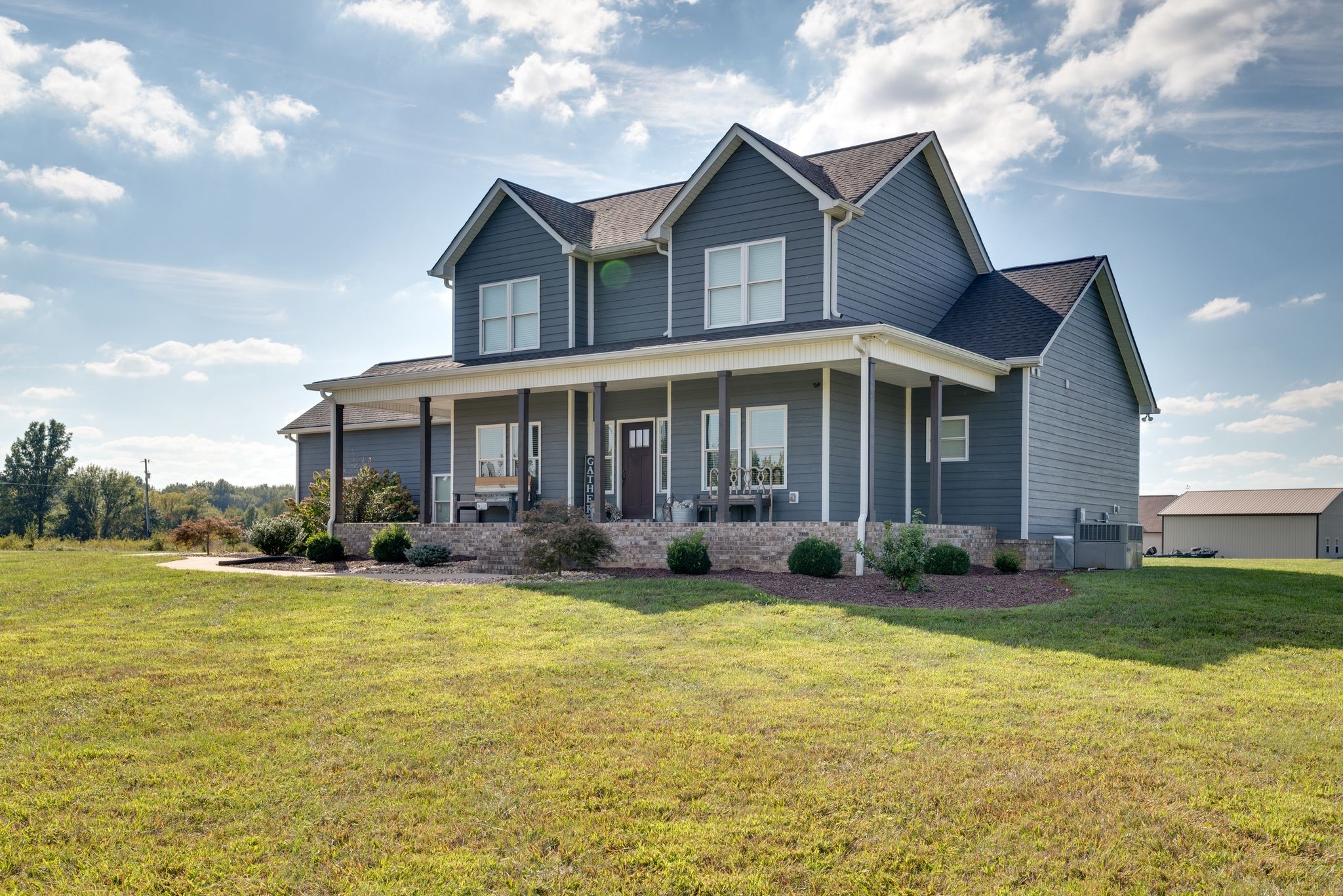 9494 Shady Park Road Portland, TN 37148 - Photo 1 of 1 a front view of a house with swimming pool having outdoor seating
