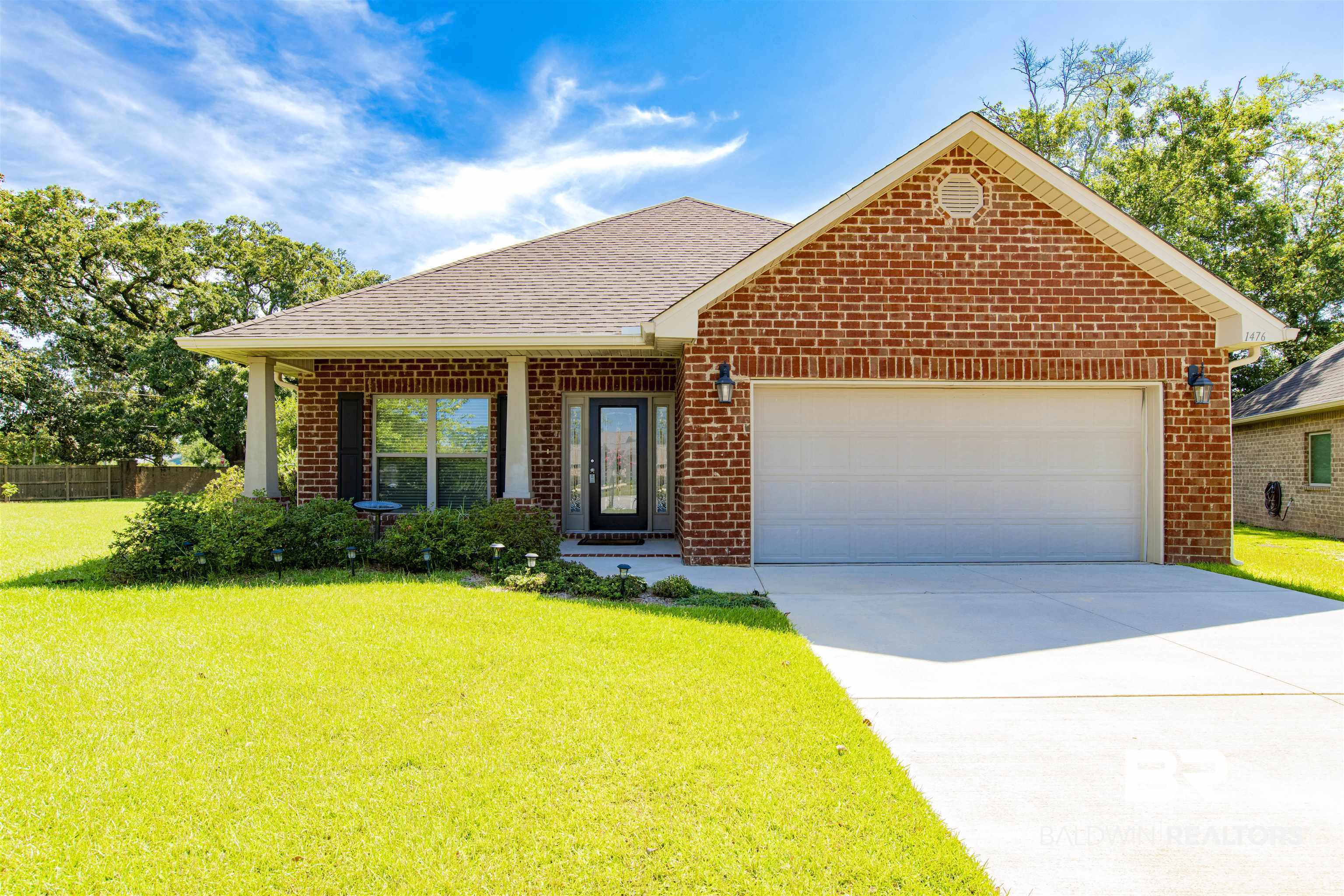 1476 Surrey Loop Foley, AL 36535 - Photo 1 of 31 View of front of property featuring brick siding, an attached garage, driveway, and roof with shingles