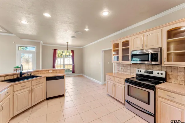 a kitchen with stainless steel appliances a stove sink and cabinets