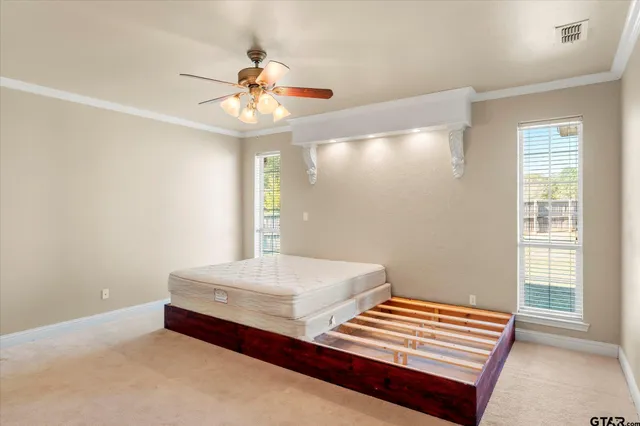 a bedroom with bed and a window