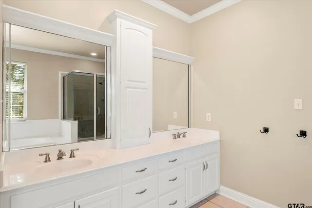 a bathroom with double vanity sink and mirror