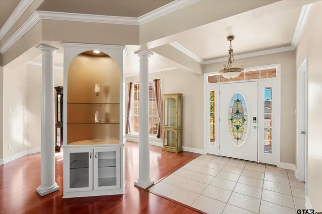 a view of a hallway with wooden floor and windows
