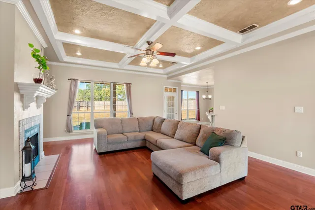 a living room with fireplace furniture and a wooden floor