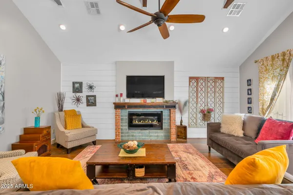 a living room with furniture and a fireplace