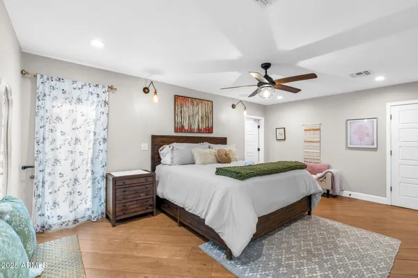 a bedroom with a bed and a ceiling fan