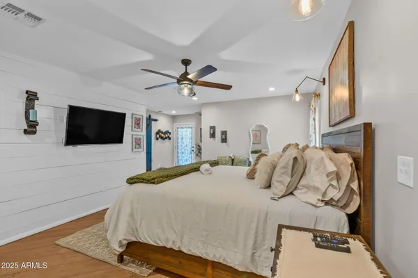 a bedroom with a bed and a flat screen tv